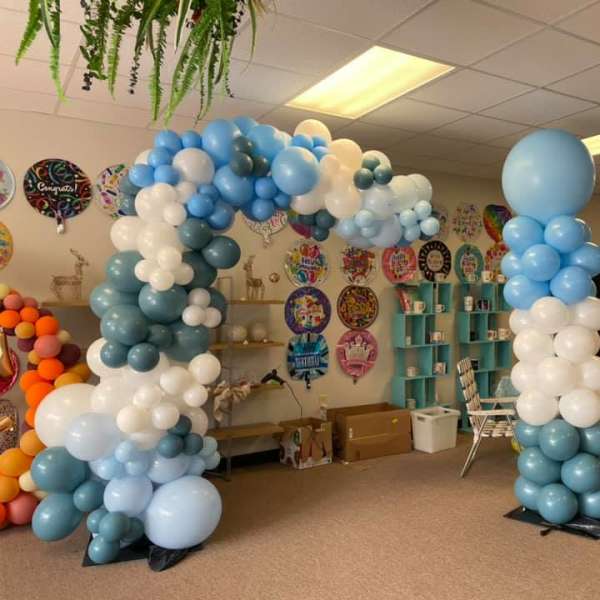 Blue and white balloon arch in a party room