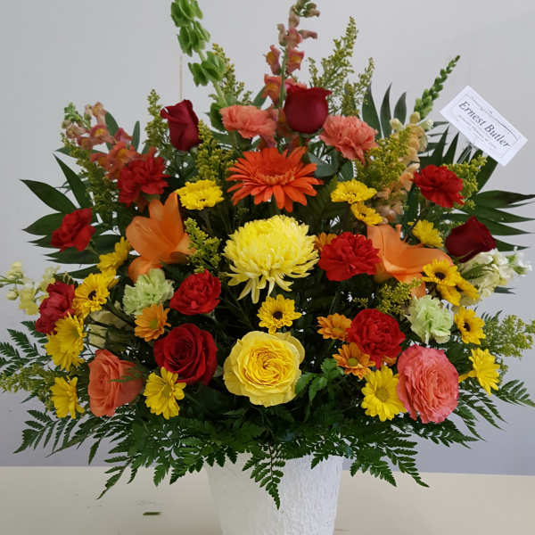 Colorful mixed flower arrangement in a white vase