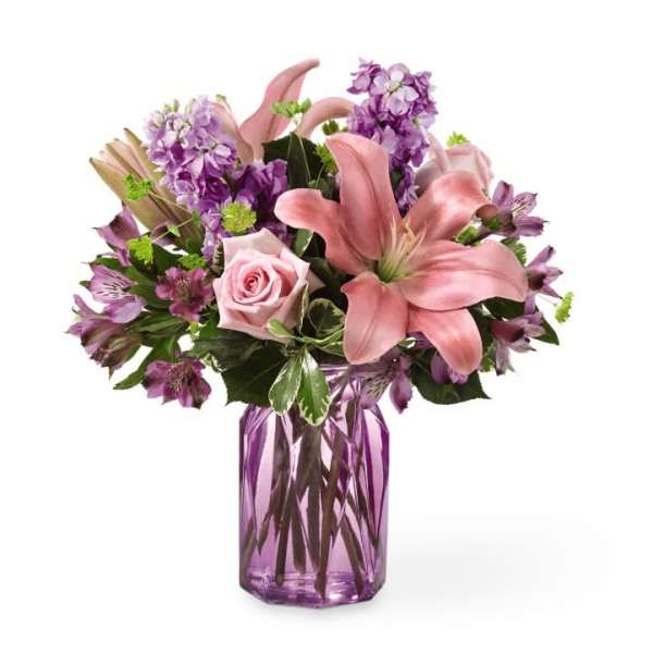 Pink lilies and roses in a purple glass vase
