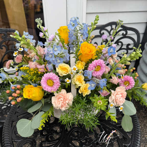 Mixed bouquet with yellow roses, pink daisies, and blue flowers