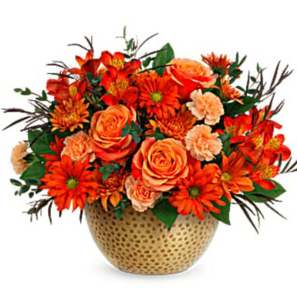 Orange roses and daisies in a gold textured vase