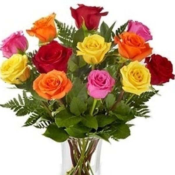 Bouquet of multicolored roses in a clear glass vase