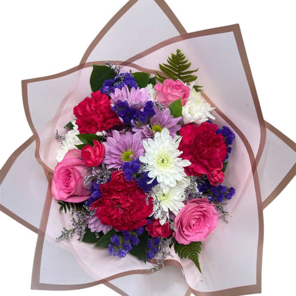 Mixed bouquet of pink, white, red, and purple flowers wrapped in pale paper