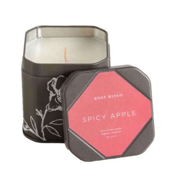 Two scented candles in square metal tins, one labeled Spicy Apple