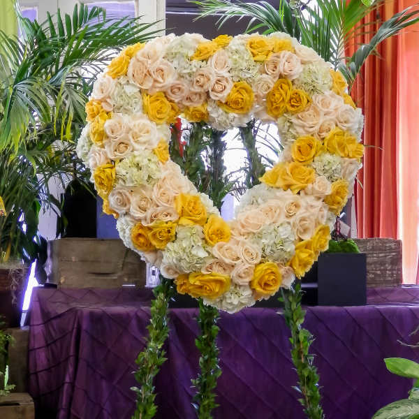 Heart-shaped floral standing spray with yellow and cream roses