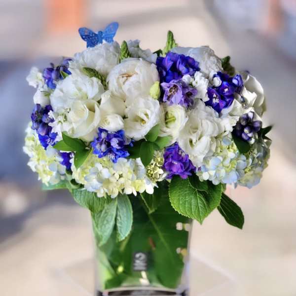 Bouquet of white and purple flowers in a green vase