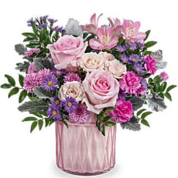 Pink and purple flower arrangement in a glass vase