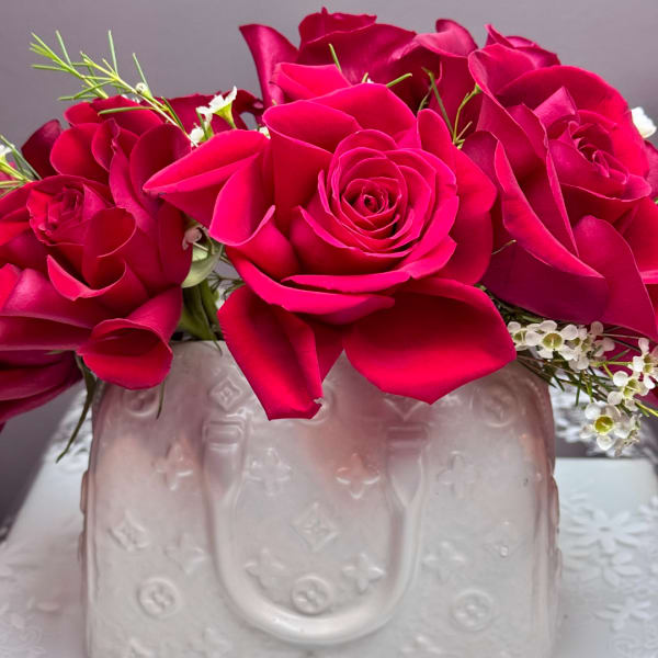 Pink rose bouquet in a pale embossed vase
