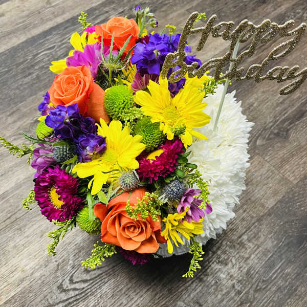 Colorful bouquet with roses, daisies, and a glittery "Happy Birthday" pick