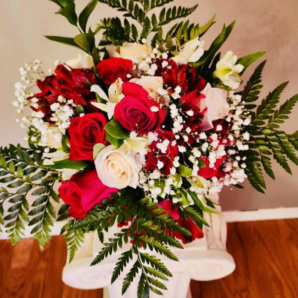 Bouquet of red and white roses with baby's breath and greenery