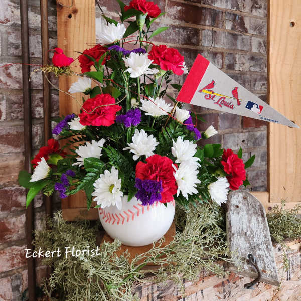 Baseball-themed floral arrangement in a white vase with a St. Louis pennant