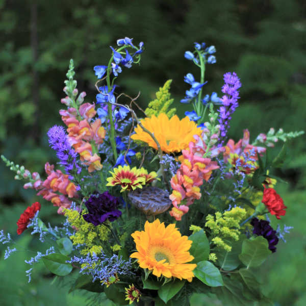 Mixed bouquet in a glass vase with bright yellow and purple flowers