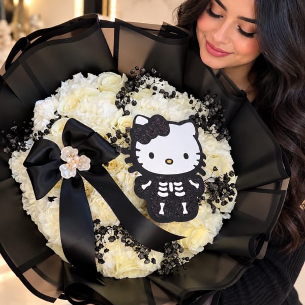 Woman holding a bouquet of white flowers with a Hello Kitty skeleton decoration