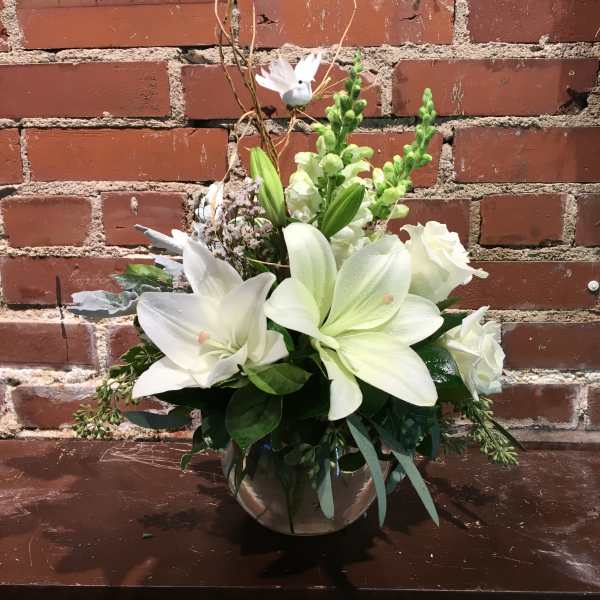 White lily and rose arrangement in a silver vase
