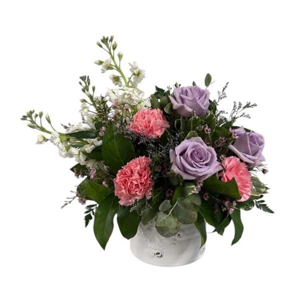 Lavender roses and pink carnations in a white vase
