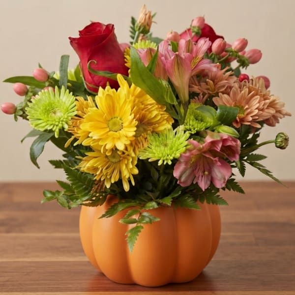 Mixed bouquet in an orange pumpkin-shaped container