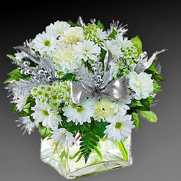 White daisy bouquet in a clear square vase with a silver ribbon