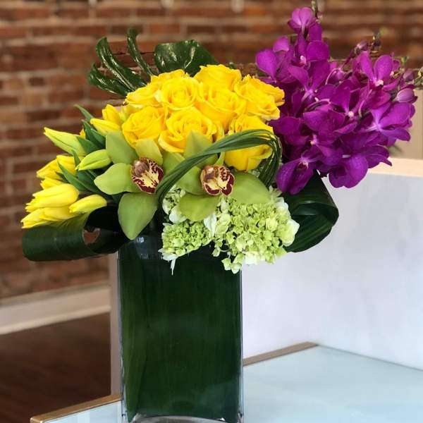 Magenta orchids and yellow roses