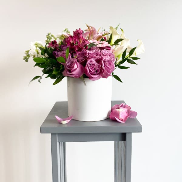 Pink and white flower arrangement in a white vase