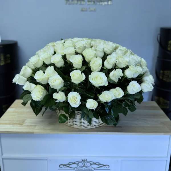 Large bouquet of white roses in a white basket