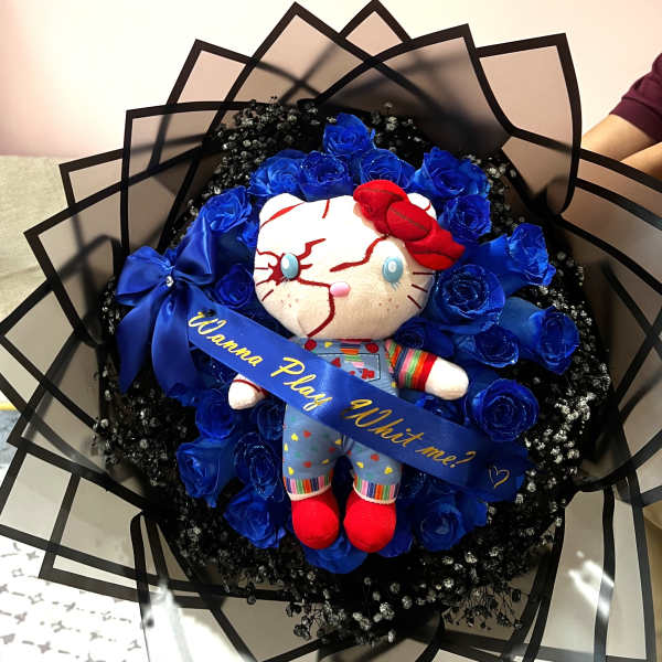 Bouquet with blue roses and a plush doll in the center