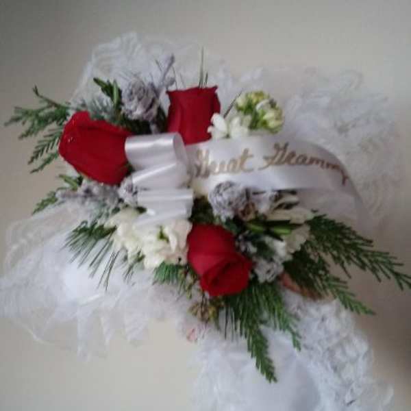 Red roses and white flowers with a white ribbon and tulle