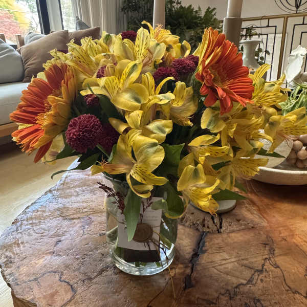 Bright yellow and orange bouquet in a clear glass vase