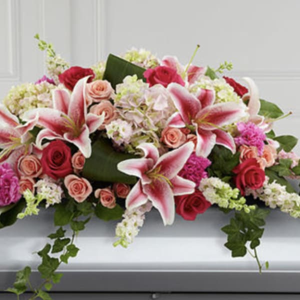 Pink lilies and roses arranged on a casket