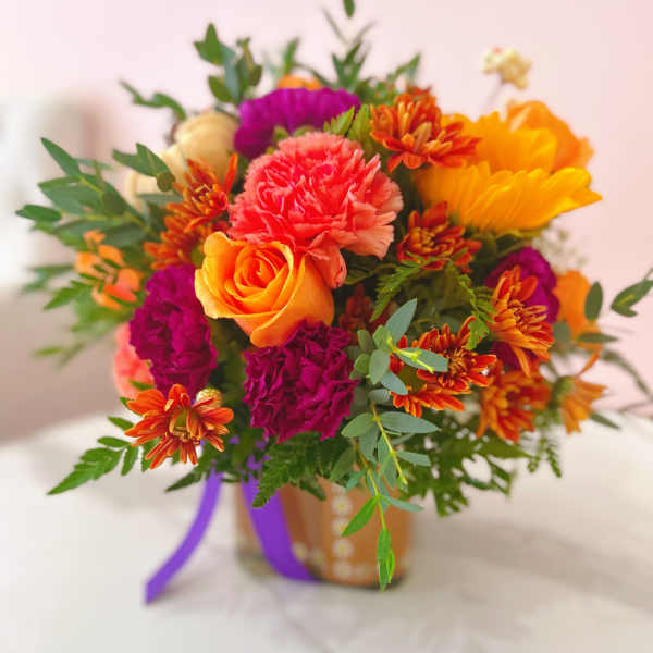 Bright mixed bouquet with roses, carnations, and chrysanthemums in a vase