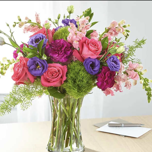 Mixed pink and purple bouquet in a clear glass vase