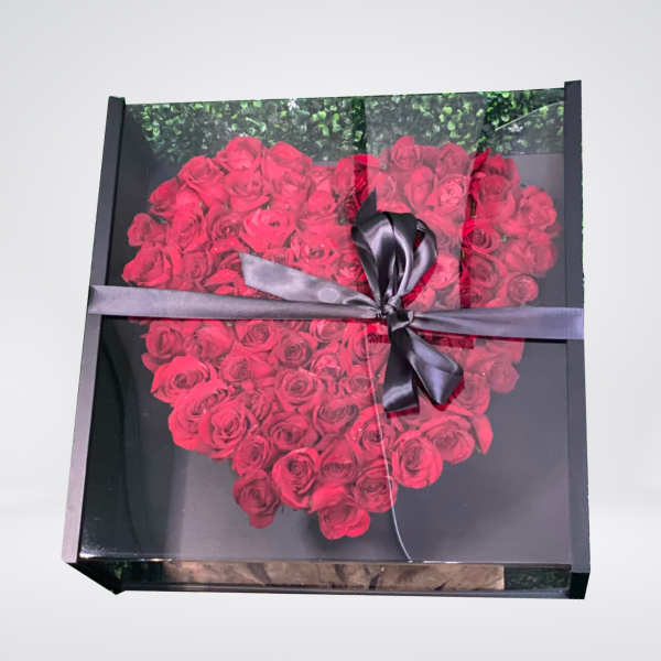Heart-shaped box of red roses tied with a black ribbon