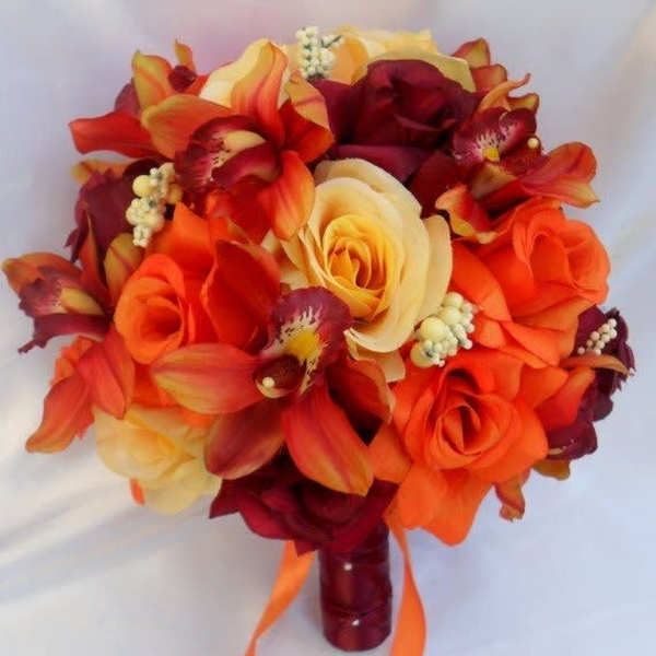 Orange and burgundy bouquet with roses and orchids, tied with ribbon