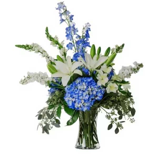 Blue and white floral arrangement in a clear glass vase