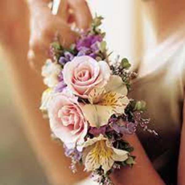 Small wrist corsage with pink roses and purple flowers