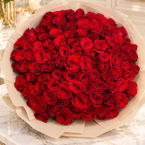 Large bouquet of red roses wrapped in cream paper