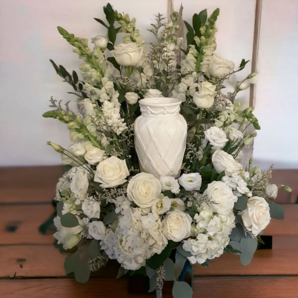 White floral arrangement with roses and hydrangeas in a white vase