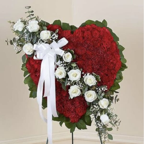 Heart-shaped red floral standing spray with white roses and ribbon