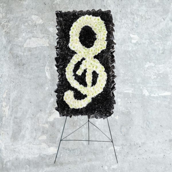 Black and white floral standing tribute on an easel