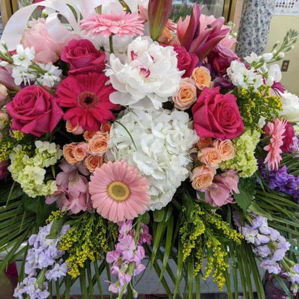 Large bouquet of pink, white, and purple flowers with lilies and roses
