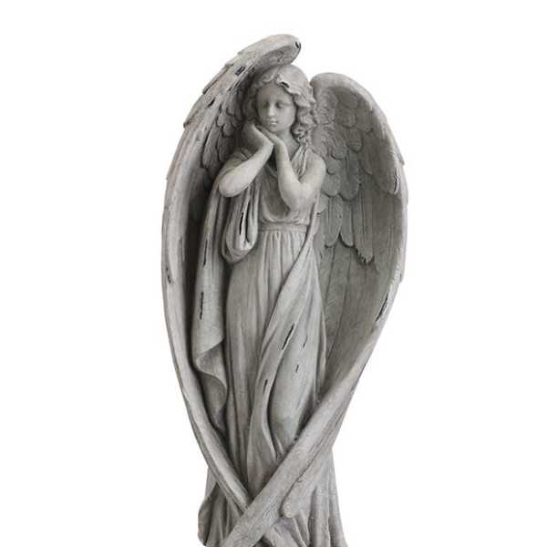 Gray angel statue with folded wings and a halo