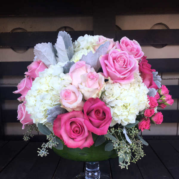 Pink and white rose bouquet in a glass vase