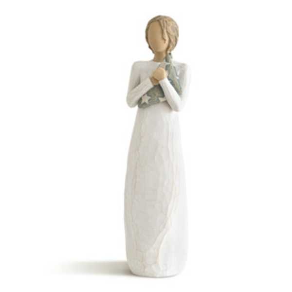 Tall angel figurine in a white dress holding a small star-patterned item