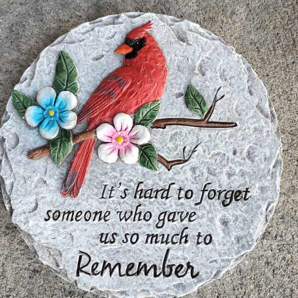 Decorative memorial stone with a red cardinal and painted flowers
