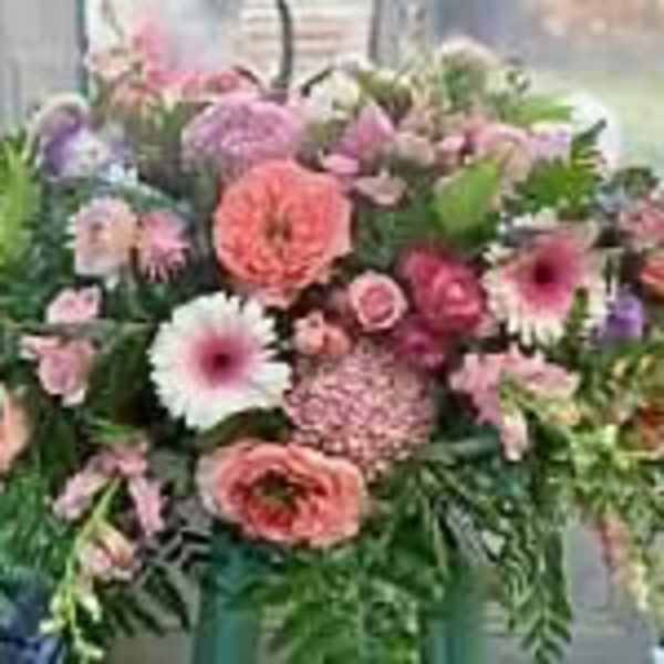 Mixed pink and purple flower arrangement in a vase