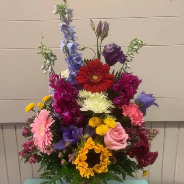 Colorful mixed flower arrangement in a glass vase