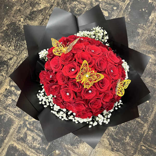 Red rose bouquet with white baby's breath and yellow butterfly decorations