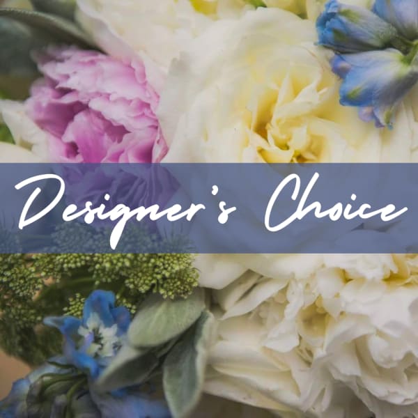 Close-up of a mixed floral arrangement with white, pink, and blue flowers and a Designer’s Choice text overlay