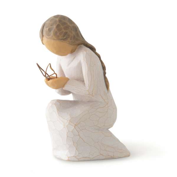 Small kneeling figurine holding a butterfly
