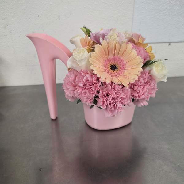 Pink floral arrangement in a pink high-heel shoe container