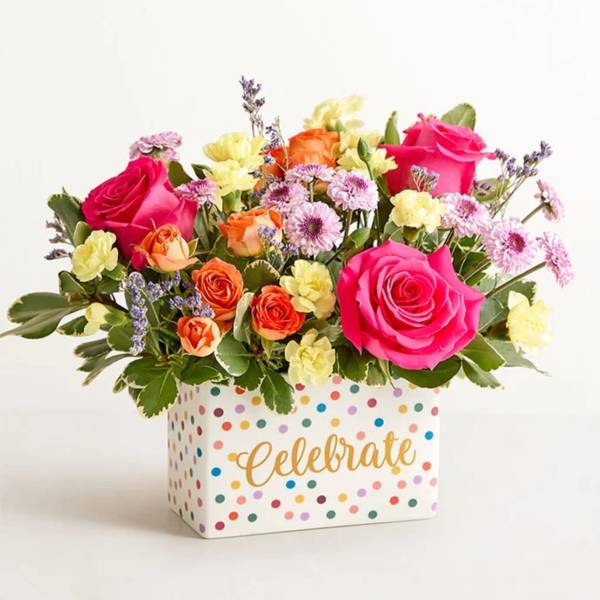 Bright mixed bouquet in a polka-dot box with "Celebrate" text